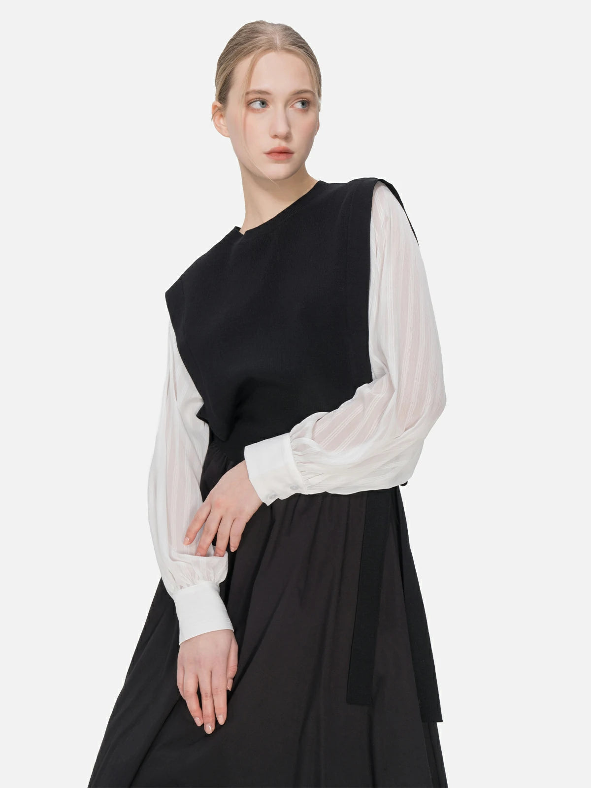Versatile chic attire: black knitted main body paired with white chiffon sleeves and a side-tie design.