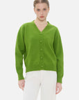 Fashionable green V-neck cardigan with front button design.