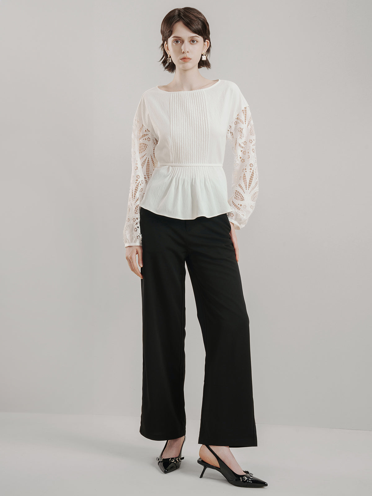 Vintage-inspired white peplum top with lace embroidery and flowy hem
