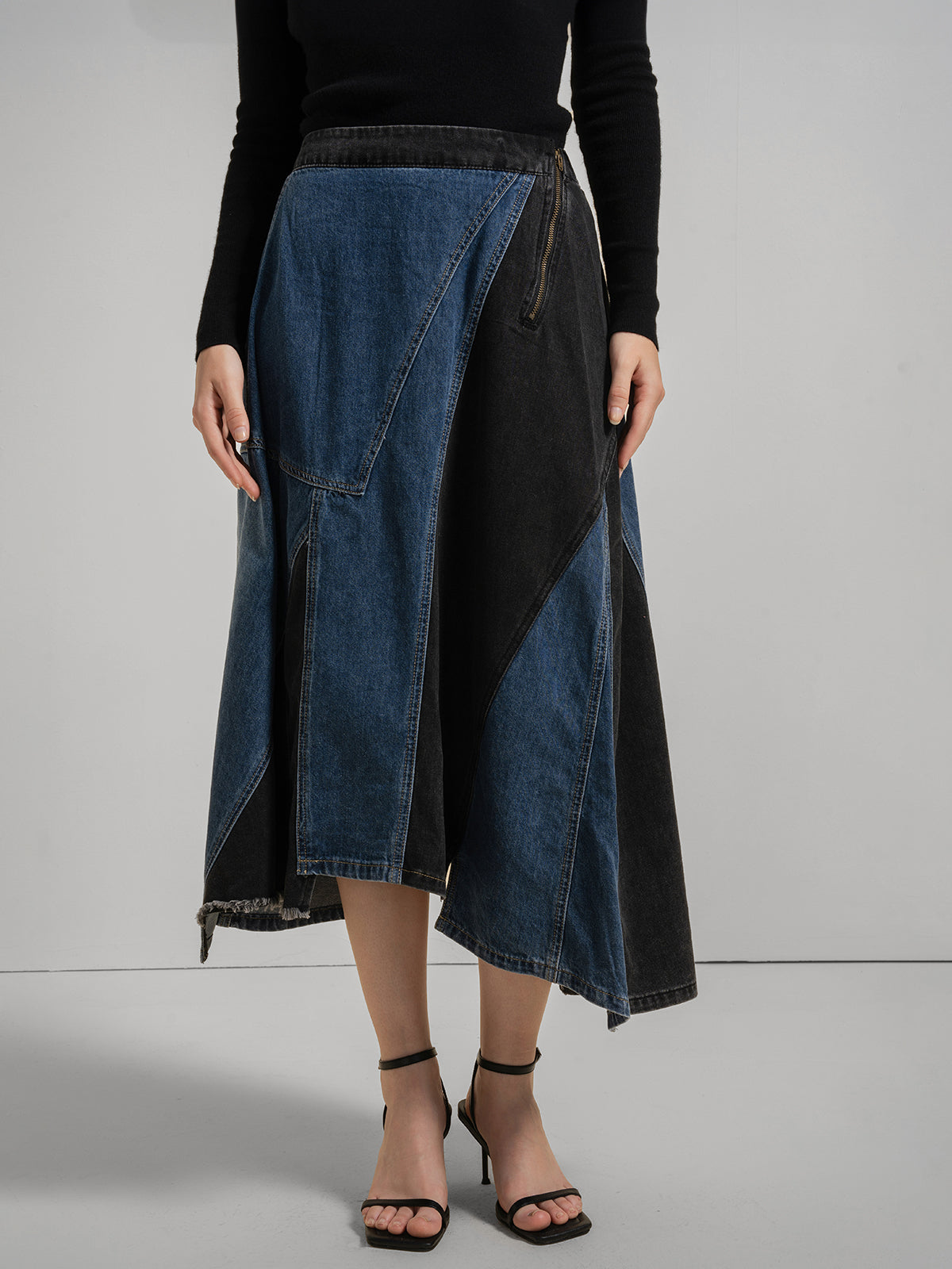 Women&#39;s patchwork denim midi skirt with asymmetrical hem, geometric blue and black panels, and side zipper detail, chic and stylish