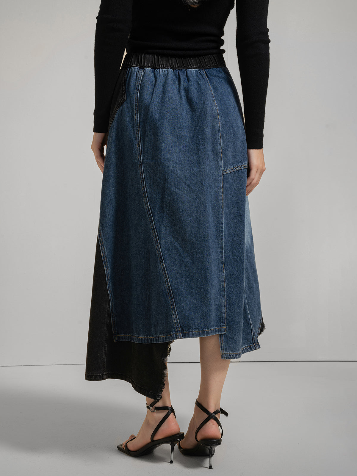 Women&#39;s patchwork denim midi skirt with asymmetrical hem, geometric blue and black panels, and side zipper detail, chic and stylish