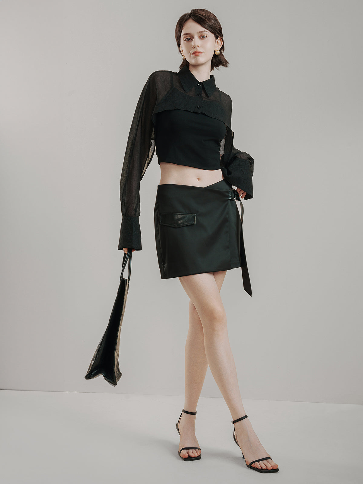 Black wrap mini skirt with side pockets and belted design