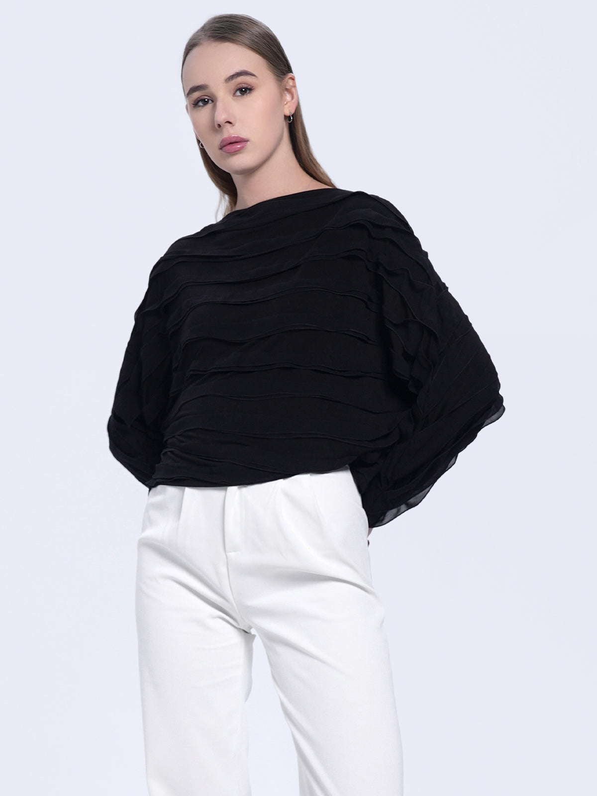 Black textured long-sleeve blouse with wavy layered design, loose fit, and modern minimalist style