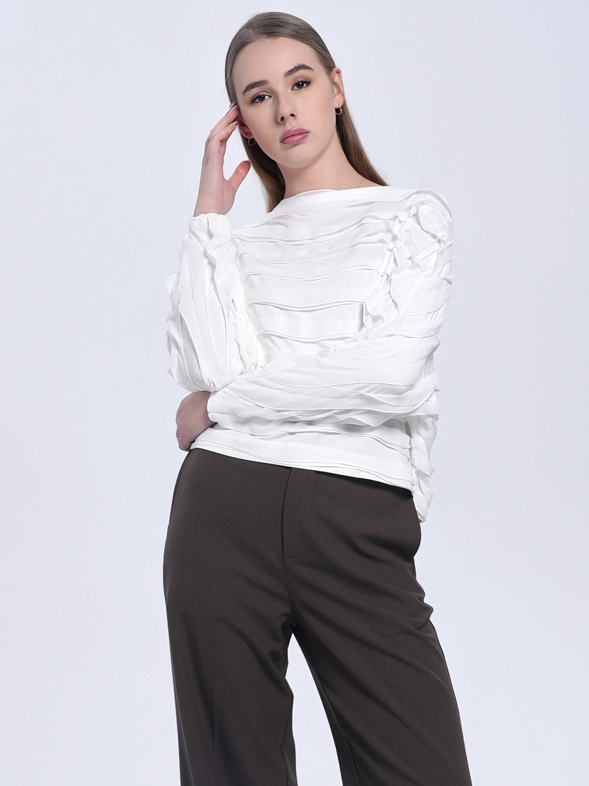 Women&#39;s white blouse with sculptural wave-like texture, relaxed silhouette, and artistic modern aesthetic for a chic and sophisticated look