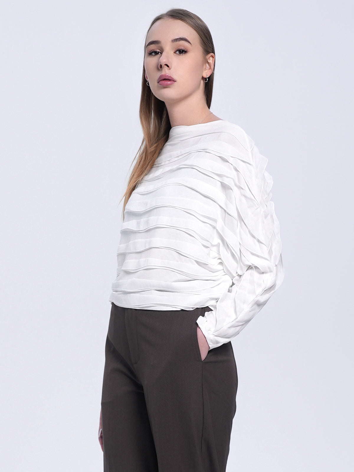 Women&#39;s white blouse with sculptural wave-like texture, relaxed silhouette, and artistic modern aesthetic for a chic and sophisticated look