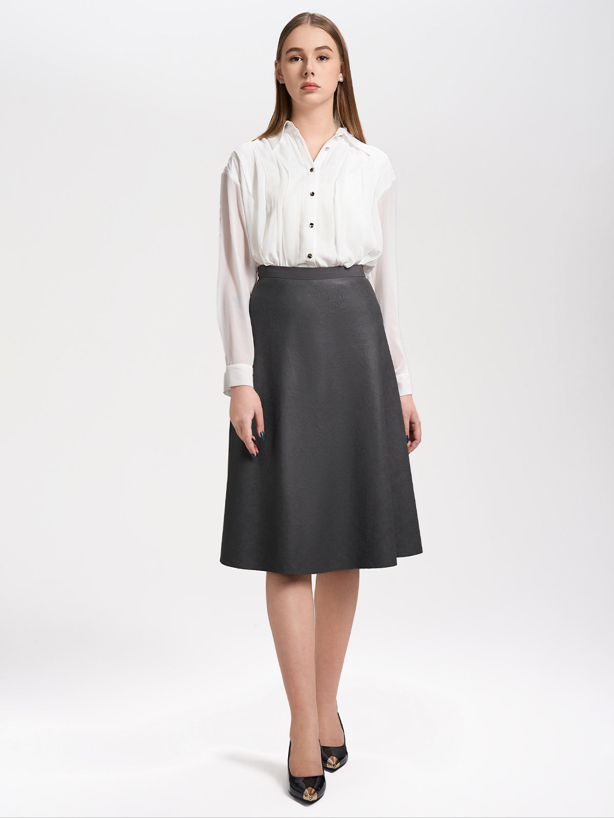 Classic white button-up blouse with delicate pleats and airy sheer sleeves, a sophisticated office outfit essential