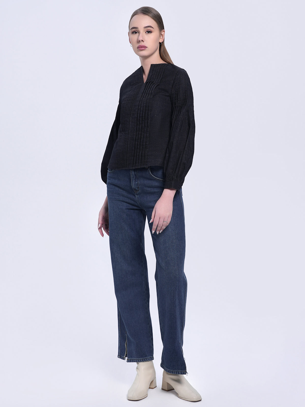Women's black linen-cotton top with a notched neckline, delicate pleat details, and puffed sleeves, a perfect blend of sophistication and comfort