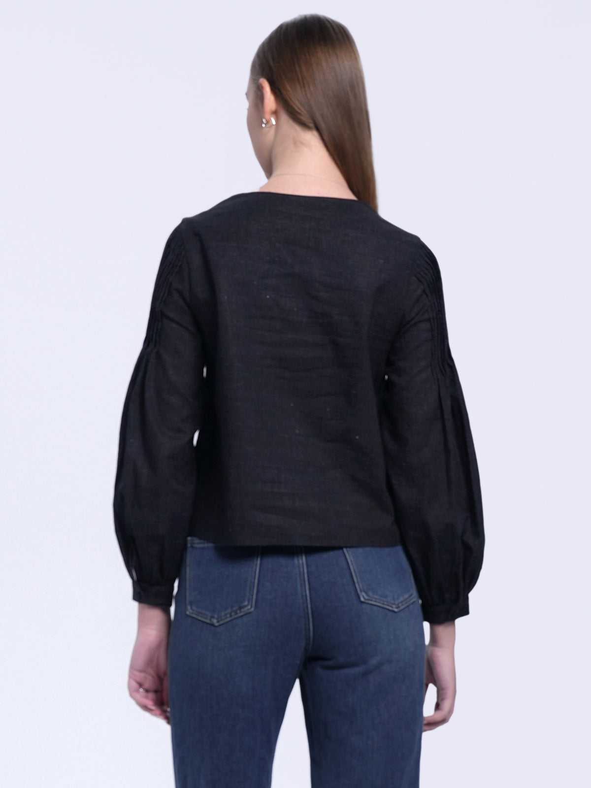 Elegant black long-sleeve top made from breathable cotton-linen blend, featuring structured pleats and a relaxed fit for versatile styling