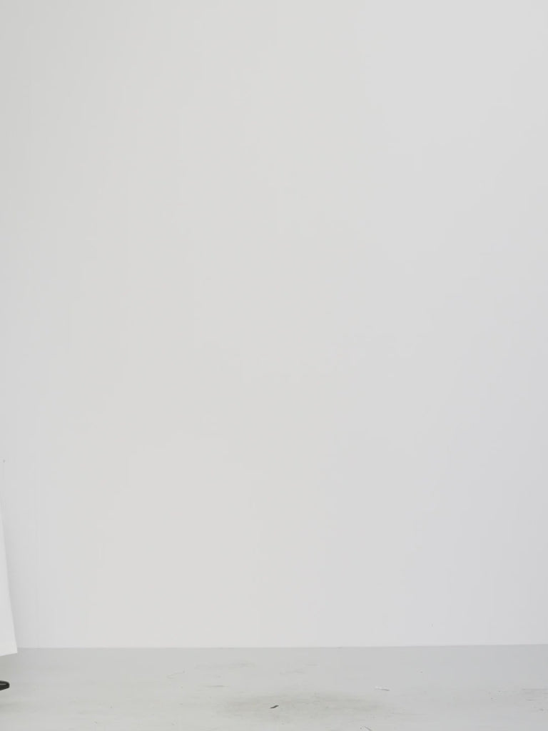 High-neck design and pleated cuff tie-waist showcasing feminine grace