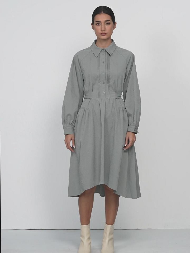 Modern high-low hemline adding dynamism to a grey dress