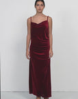 Velvet spaghetti strap maxi dress with irregular V-neck and pleated detailing, suitable for various occasions