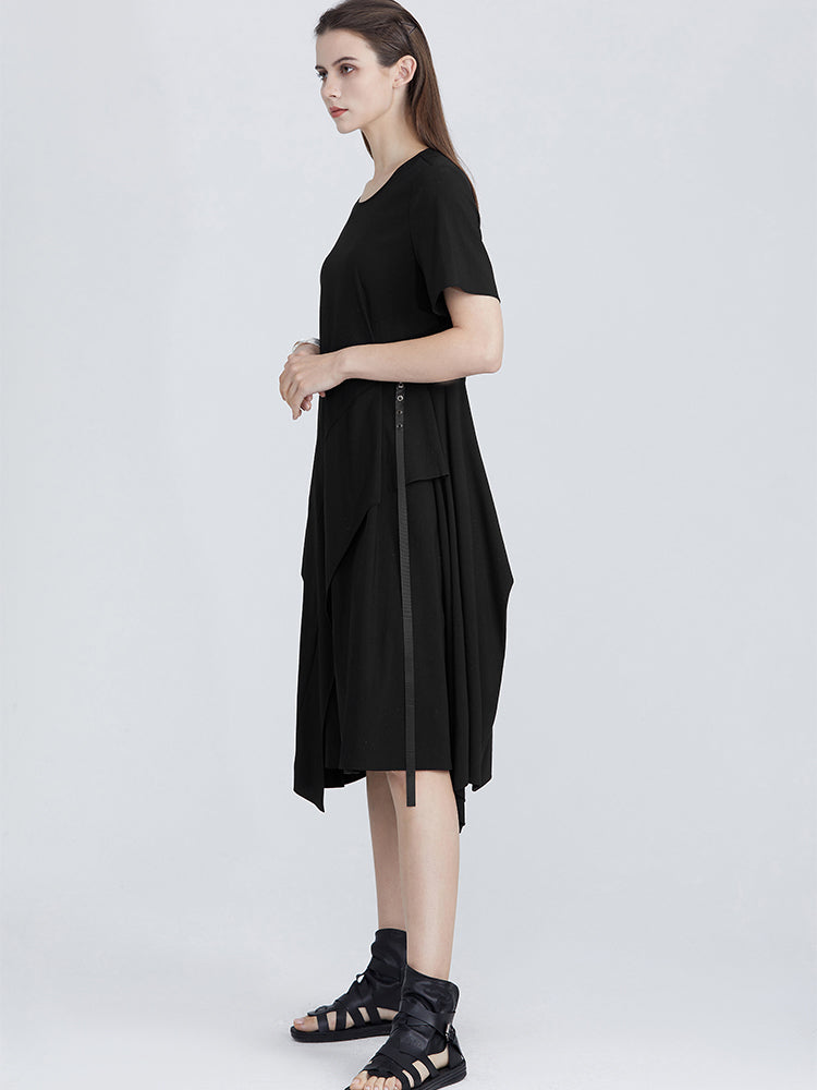 Side view of black A-line dress with clean lines, short sleeves, and a zipper accent at the waist, offering a minimalist yet stylish design